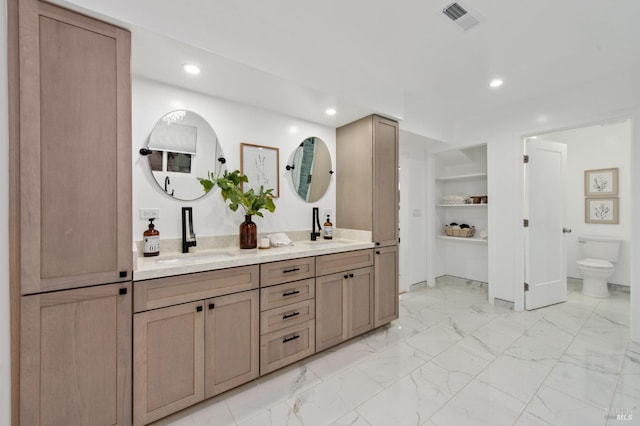 bathroom with vanity and toilet