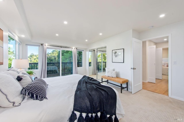 bedroom featuring multiple windows, light carpet, and access to outside