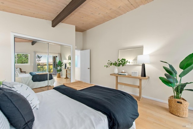 bedroom featuring vaulted ceiling with beams, light hardwood / wood-style floors, a closet, and wooden ceiling