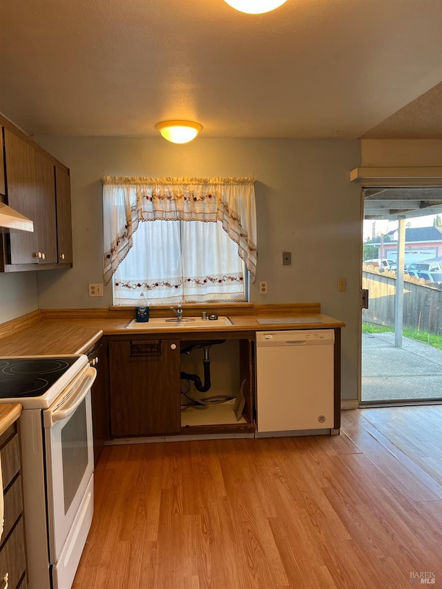 kitchen with light hardwood / wood-style floors, white appliances, and ventilation hood