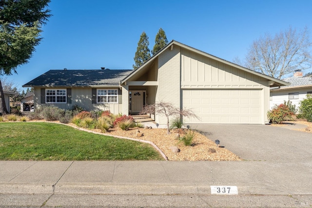 ranch-style home with a garage and a front lawn