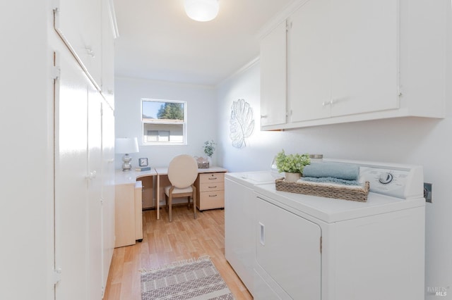 washroom with light wood-type flooring, cabinet space, ornamental molding, and independent washer and dryer