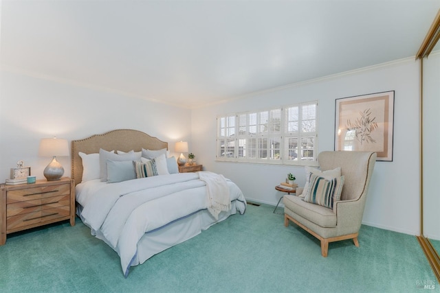 carpeted bedroom with baseboards and crown molding