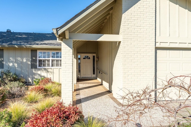 doorway to property with a garage