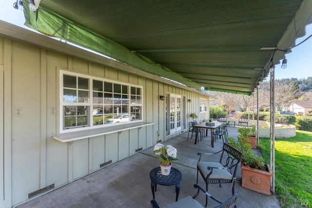 view of patio / terrace featuring french doors, outdoor dining space, and visible vents