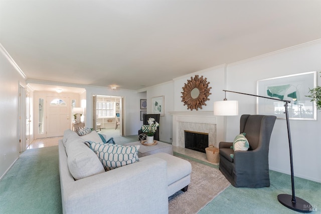 living room with ornamental molding, carpet, a fireplace, and baseboards