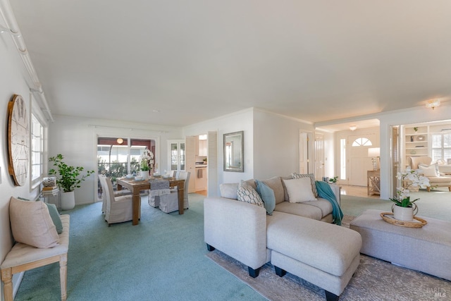 carpeted living area with crown molding