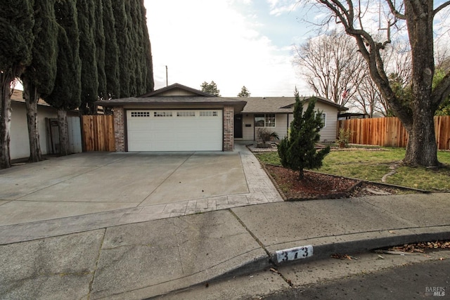 ranch-style home featuring a garage and a front yard