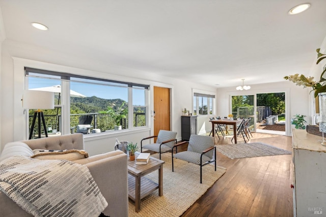 living room featuring a chandelier, a mountain view, and hardwood / wood-style flooring