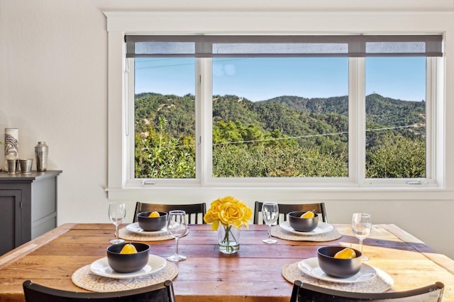 dining area with a wealth of natural light and a mountain view