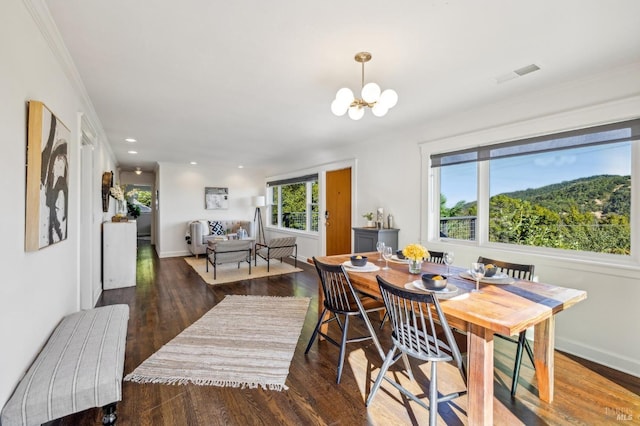 dining room with dark hardwood / wood-style flooring and a notable chandelier