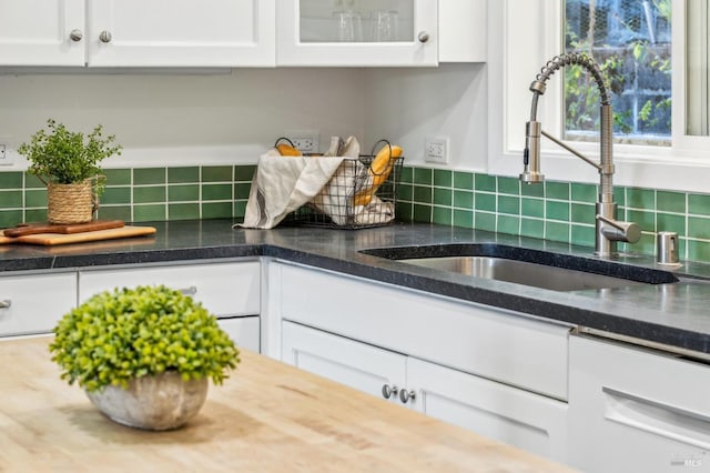 kitchen featuring white cabinets and sink