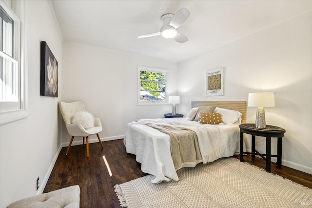 bedroom with ceiling fan and dark hardwood / wood-style flooring