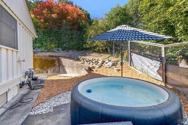 view of pool with a hot tub