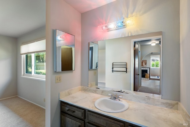 bathroom with a fireplace and vanity