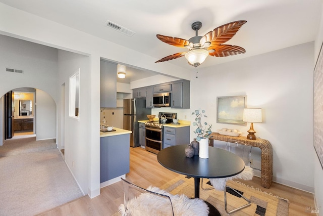 dining space with ceiling fan and light hardwood / wood-style flooring