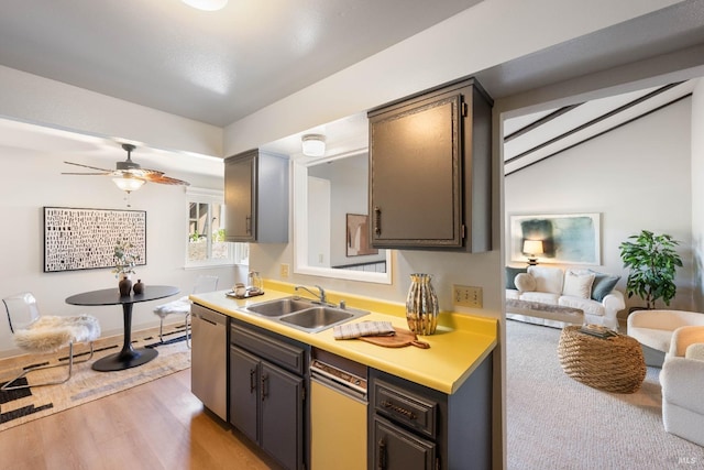 kitchen featuring ceiling fan, sink, dishwasher, and light wood-type flooring