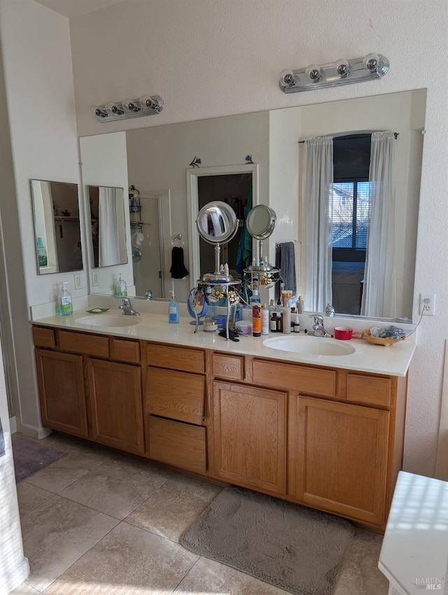 bathroom featuring walk in shower and vanity