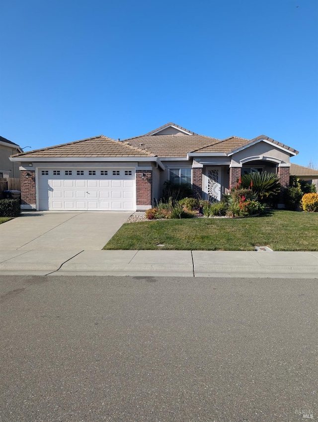 ranch-style house featuring a front yard and a garage