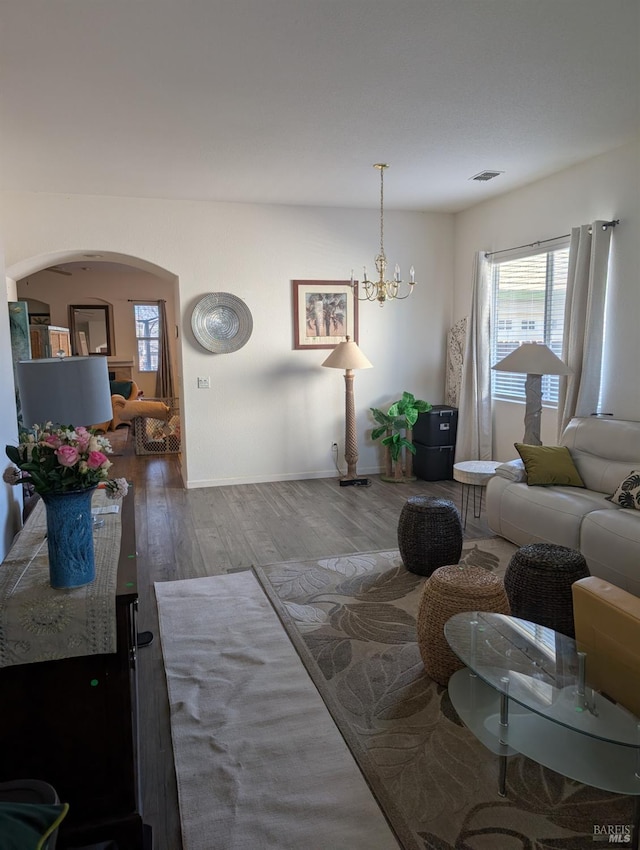 living room featuring an inviting chandelier and hardwood / wood-style flooring