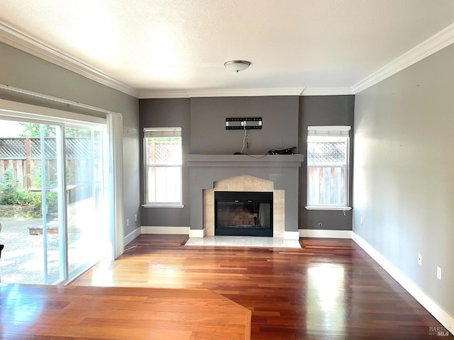 unfurnished living room featuring crown molding and wood-type flooring