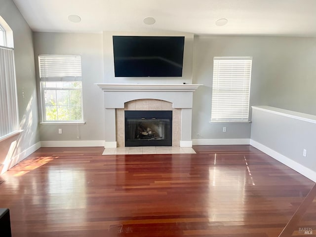 unfurnished living room with wood-type flooring and a fireplace