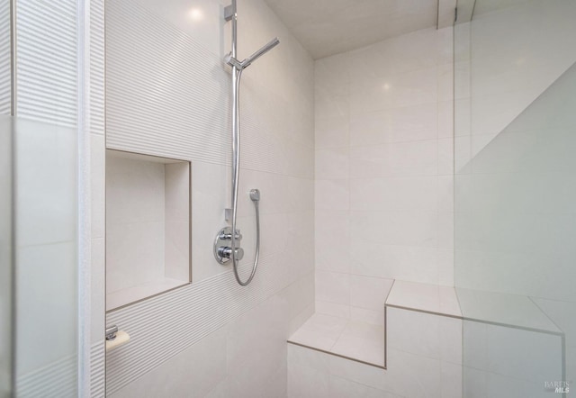 bathroom with tiled shower