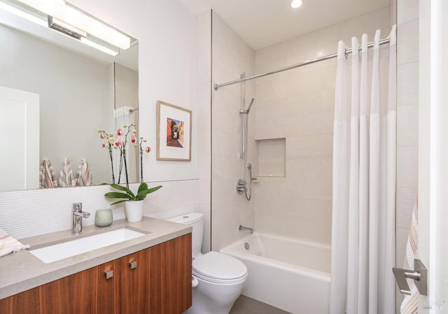 bathroom featuring shower / bath combination with curtain, vanity, and toilet