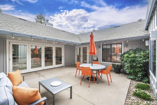 view of patio featuring outdoor dining space, french doors, and an outdoor living space