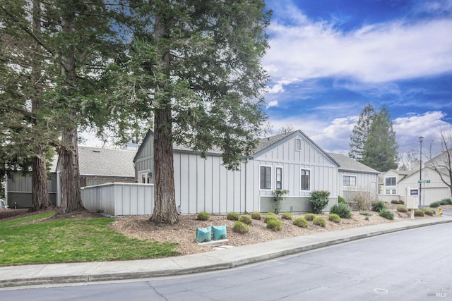 view of front of house with board and batten siding and fence