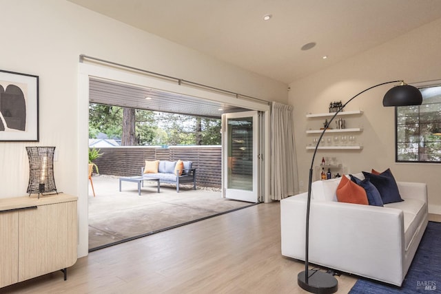 living room with lofted ceiling, wood finished floors, and recessed lighting