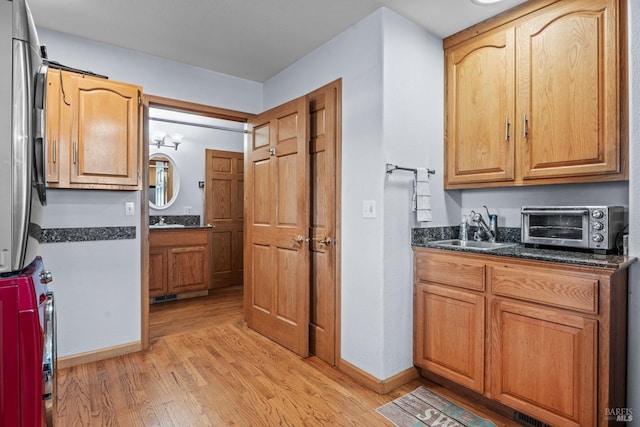 kitchen with sink and light hardwood / wood-style flooring