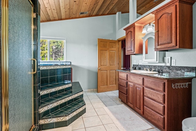 kitchen with light tile patterned floors, wood ceiling, lofted ceiling, dark stone counters, and sink