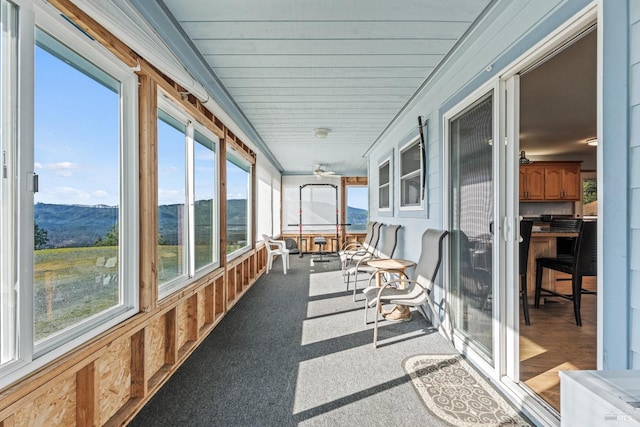 sunroom / solarium with a mountain view