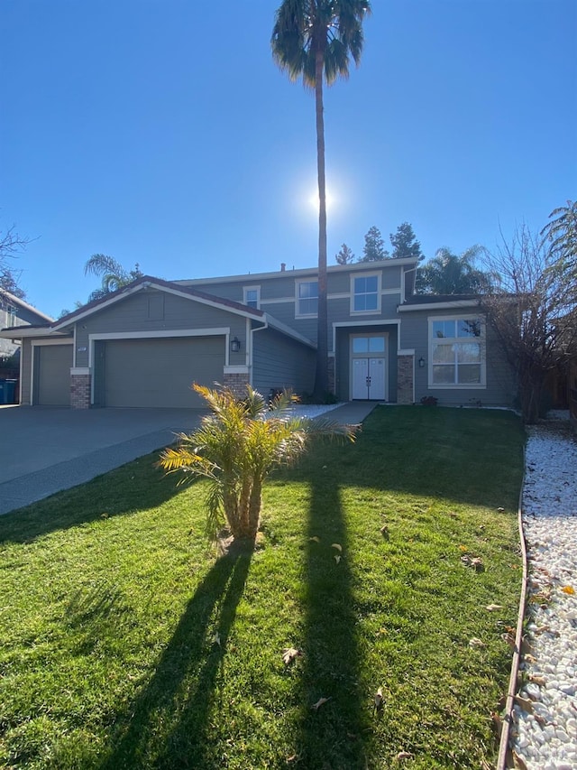 front facade featuring a garage and a front yard