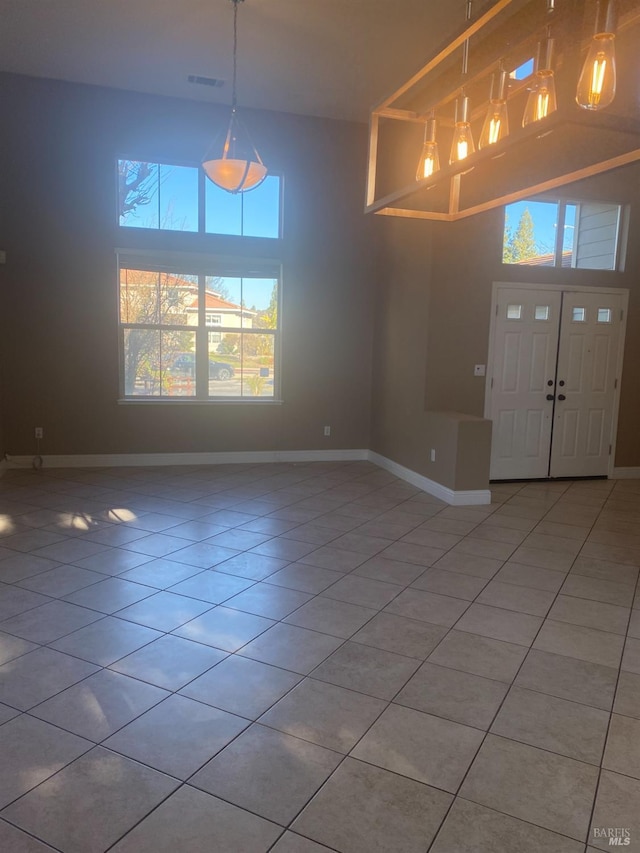 tiled foyer entrance featuring a high ceiling