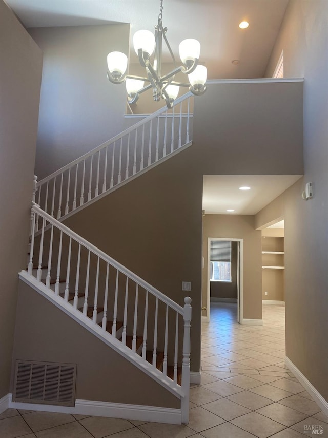 stairs featuring built in features, tile patterned floors, and a chandelier