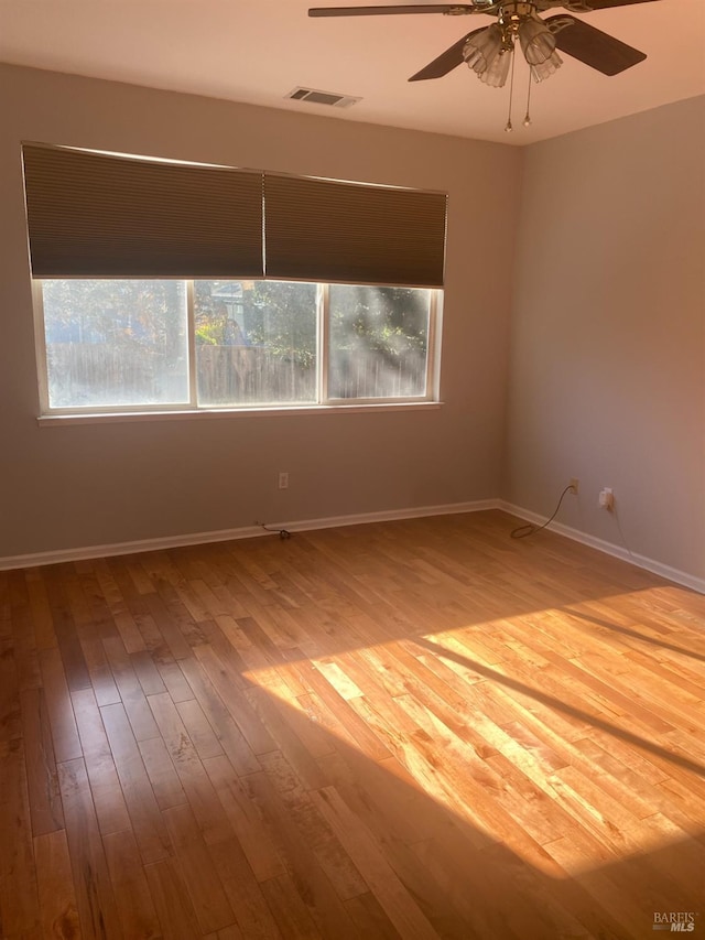 unfurnished room featuring ceiling fan and hardwood / wood-style floors