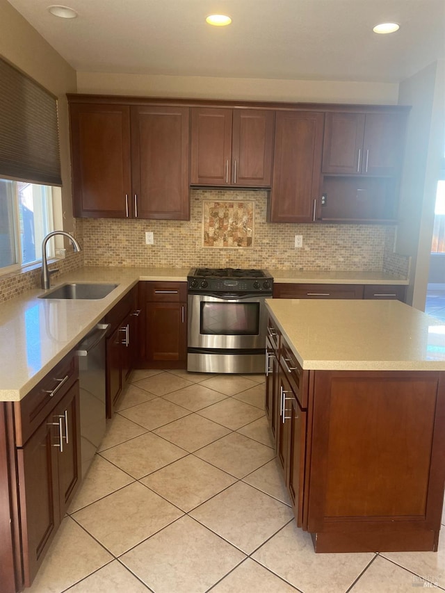 kitchen with backsplash, dishwasher, sink, and gas stove