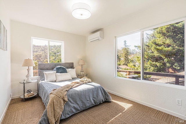 bedroom with a wall mounted AC and carpet flooring