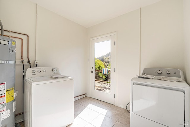 laundry room with washer and dryer, strapped water heater, and light tile patterned flooring