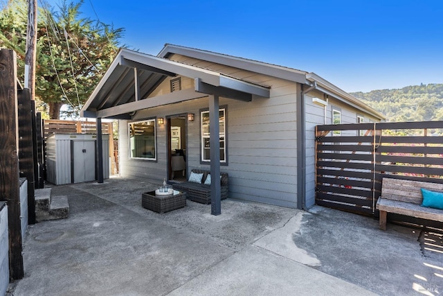 view of front of property with a patio area and a mountain view