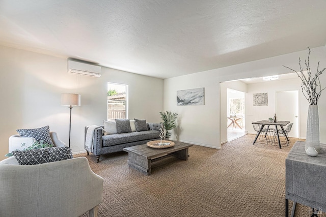 carpeted living room featuring a wall unit AC and a textured ceiling