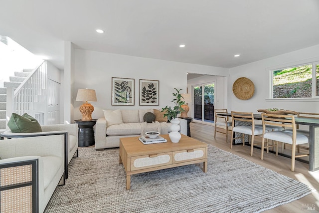 living room with plenty of natural light and light hardwood / wood-style flooring