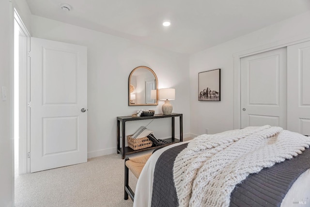 bedroom featuring light colored carpet and a closet