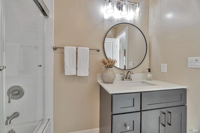 bathroom featuring vanity and tiled shower / bath