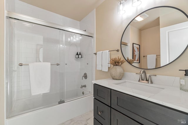 bathroom featuring shower / bath combination with glass door and vanity