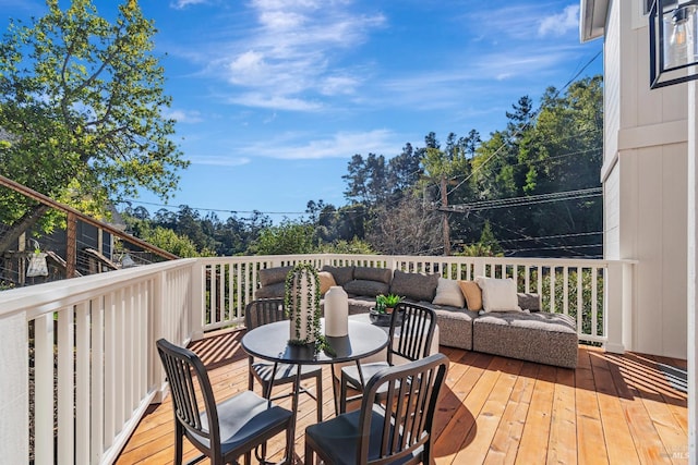 wooden terrace featuring an outdoor living space