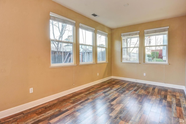 unfurnished room with dark hardwood / wood-style floors