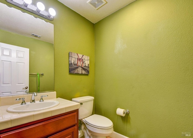 bathroom with toilet and vanity